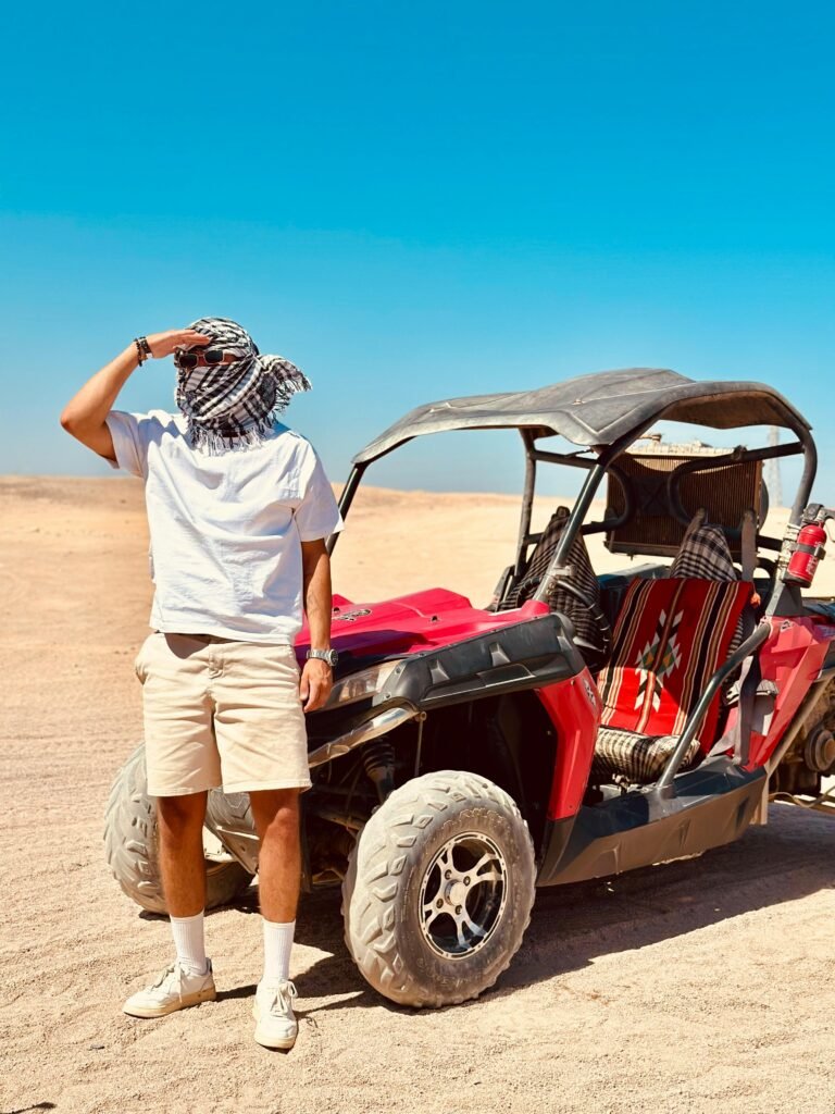 Man exploring the Egyptian desert with a dune buggy on a sunny day.