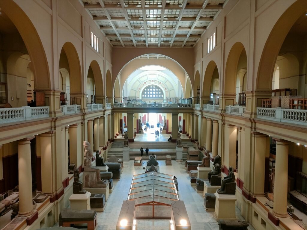 Wide view of the Egyptian Museum's main hall showcasing ancient sculptures and architecture.