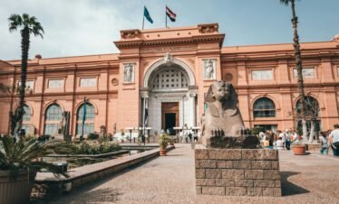 Explore the historic facade of the Egyptian Museum with its iconic sphinx statue.