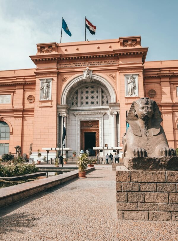 Explore the historic facade of the Egyptian Museum with its iconic sphinx statue.
