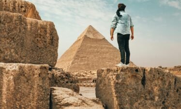A traveler admiring the ancient Pyramids of Giza, an iconic symbol of Egypt.